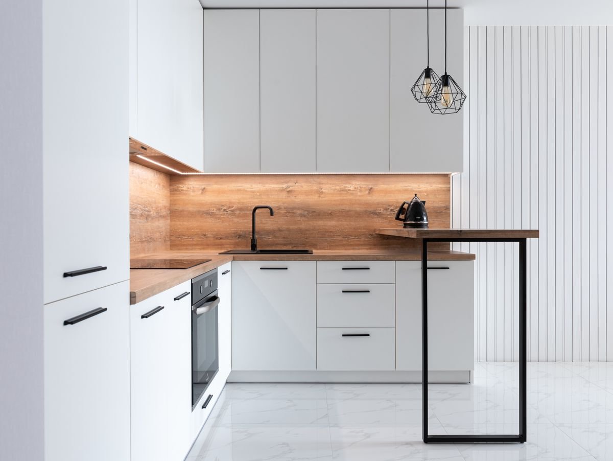 Modern white kitchen with a stack of shallow and deep drawers