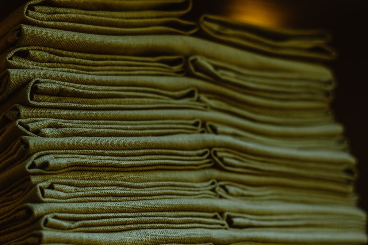 Close-up of a tall stack of neatly folded linen fabric